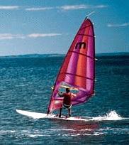 A sailboarder on the water at Youghall Beach